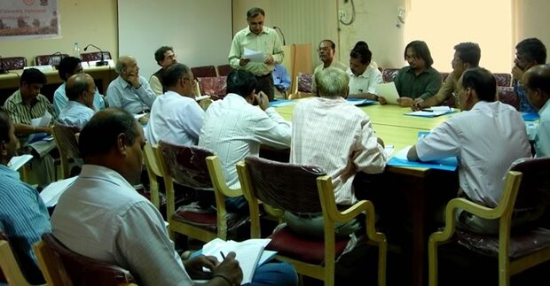 Dr. Rathore and training workshop participants around a table