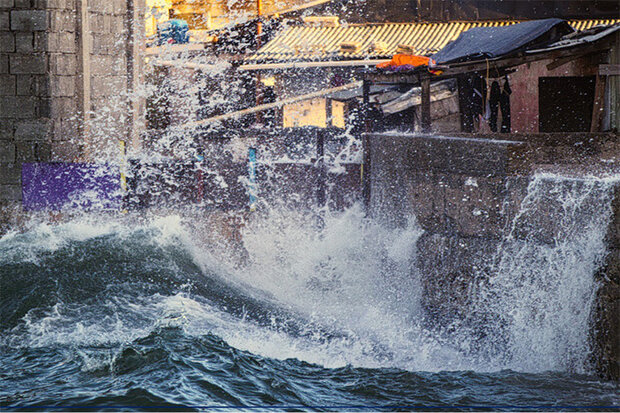 Waves splash over a seawall