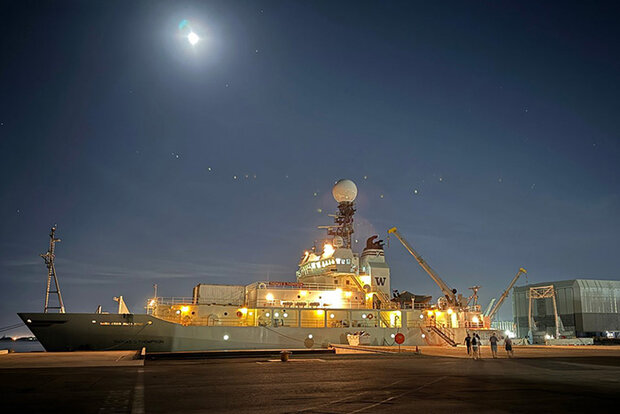 Research vessel at dock at night