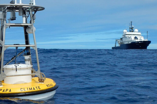 NOAA research vessel in background, buoy in foreground