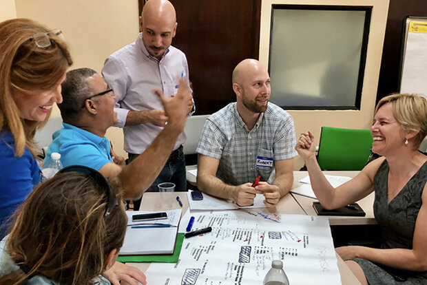 People in discussion around table