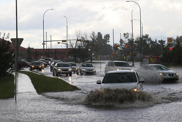 Cars driving though high water at intersection