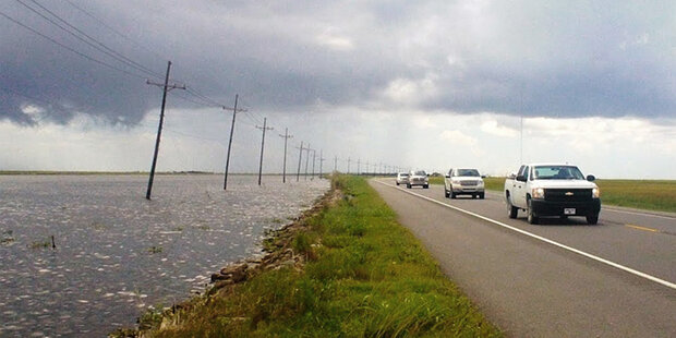 Stretch of LA highway one showing flood waters at edge of road
