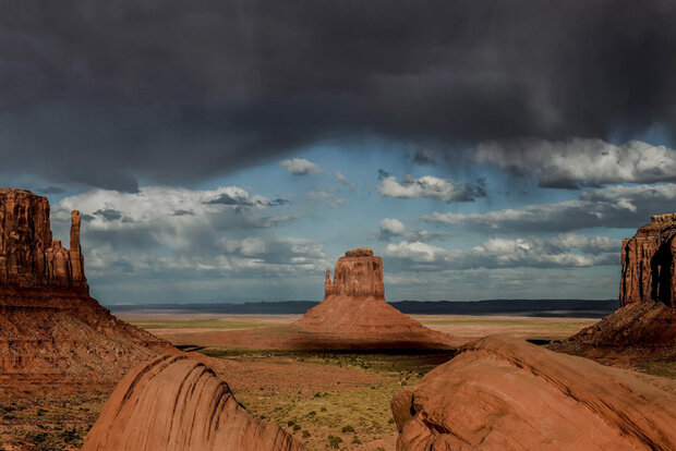 Photo of a thunderstorm beginning over Monument Valley, AZ